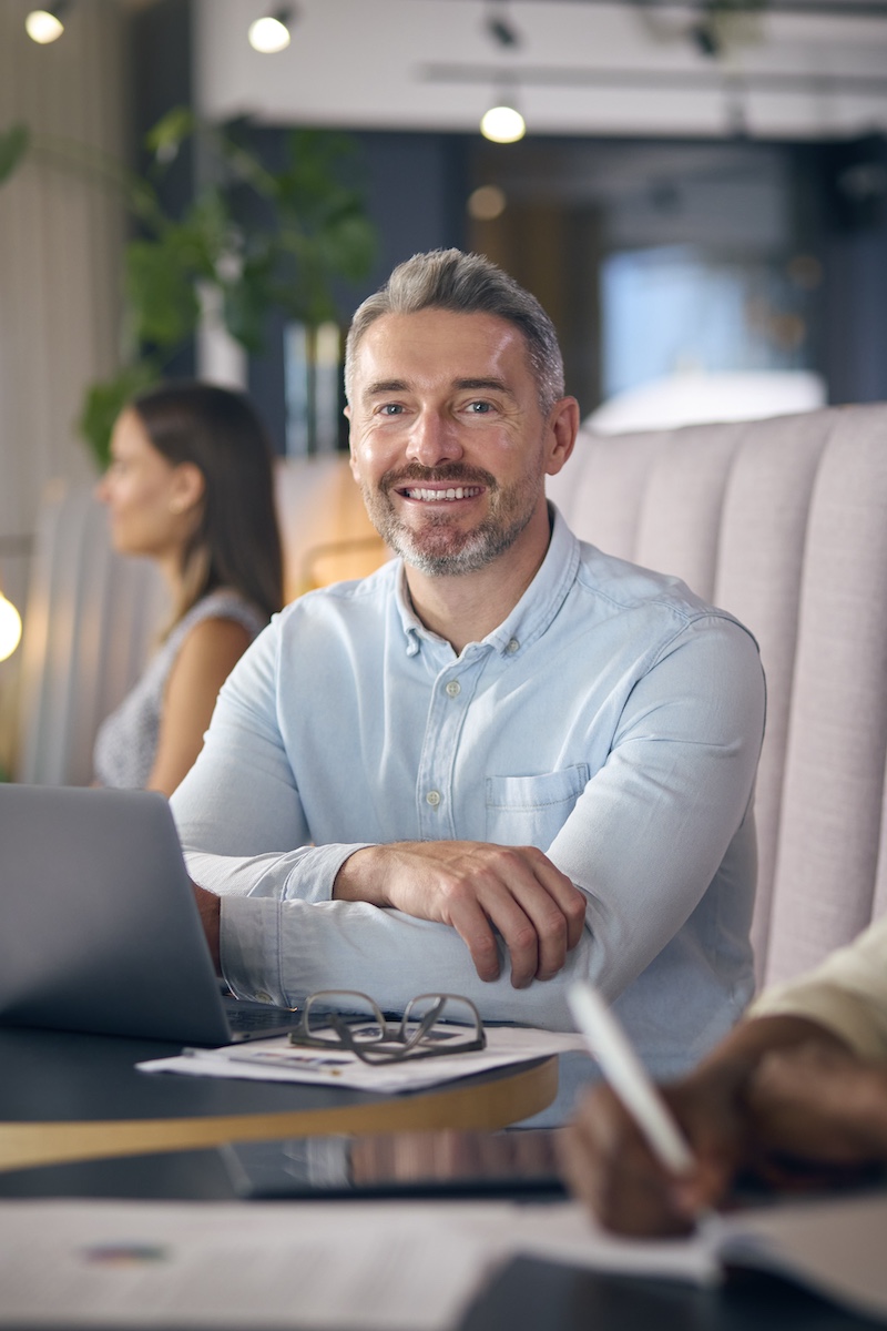 Joe Welch from Rhino Group Consulting a certified Zoho Partner smiling at his laptop
